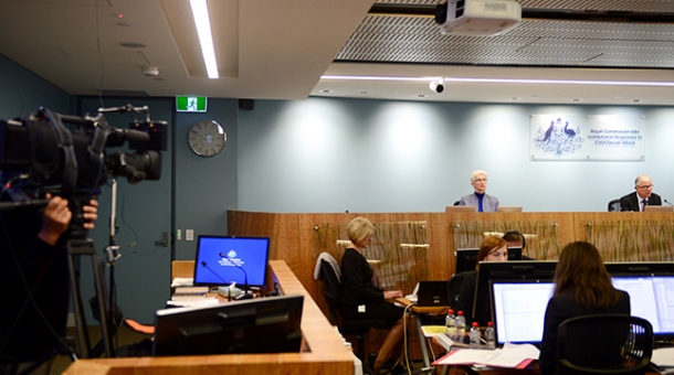 A video camera capturing footage of the public hearing