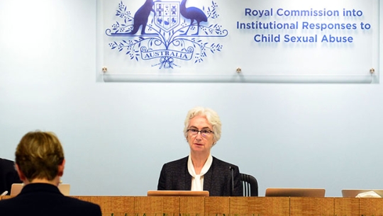 Justice Jennifer Coate Justice Jennifer Coate sitting at a bench