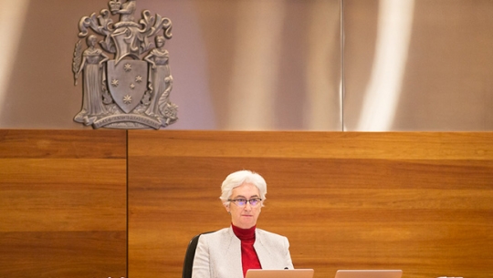 Justice Jennifer Coate Justice Jennifer Coate sitting at a bench