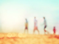 Family walking in the distance on the beach